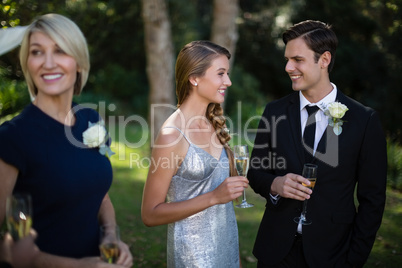 Happy couple having champagne during wedding