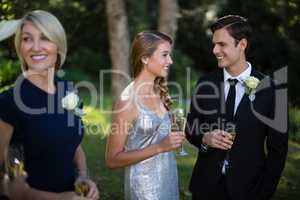 Happy couple having champagne during wedding