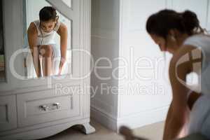 Bride wearing stockings in living room