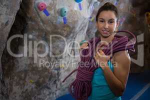 Happy woman with rope in fitness studio