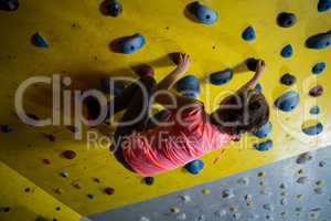 Teenage girl practicing rock climbing