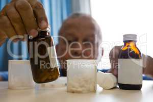 Senior man taking medicines in retirement home