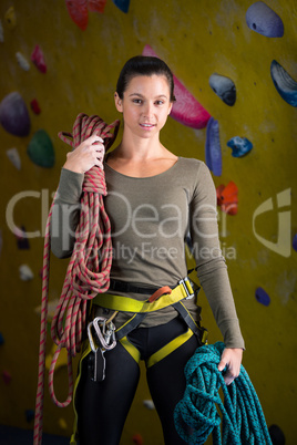 Happy woman with rope in fitness studio