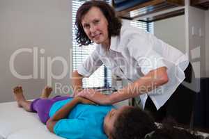 Physiotherapist giving hand massage to a patient in clinic