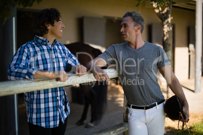 Two male friends interacting with each other in the ranch