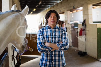 Man standing with arms crossed in the ranch