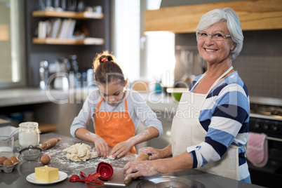 Granddaughter kneading dough