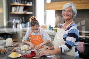 Granddaughter kneading dough