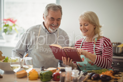 Senior couple preparing food in kitchen