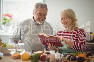 Senior couple preparing food in kitchen