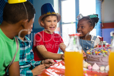 Children talking while sitting at table