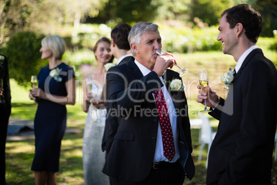 Guests having champagne while attending wedding