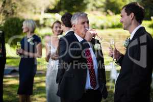 Guests having champagne while attending wedding