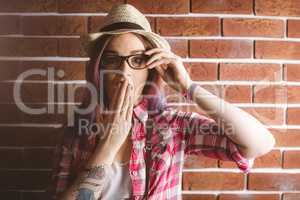 Portrait of shocked woman with hand on mouth