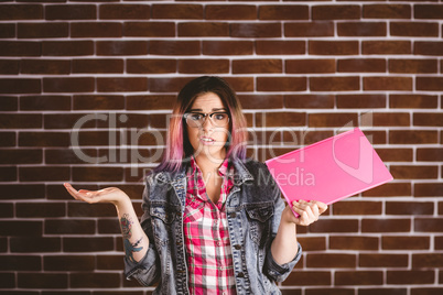 Portrait of confused woman holding file