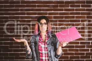 Portrait of confused woman holding file