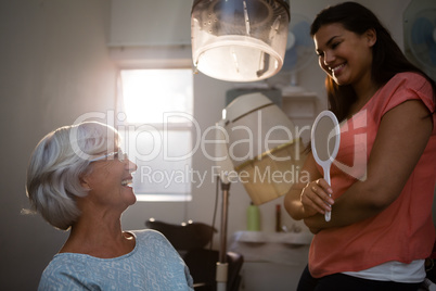 Hairstylist talking to senior woman