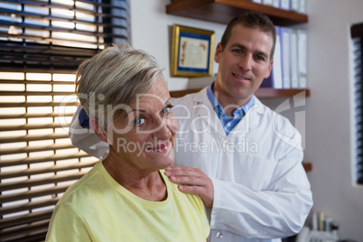 Physiotherapist examining neck of a female patient