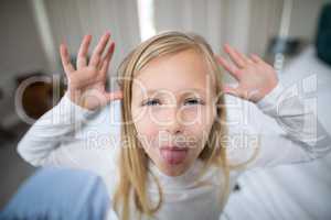 Portrait of girl making facial expression in bedroom