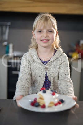 Little girl posing with a fruit pancake