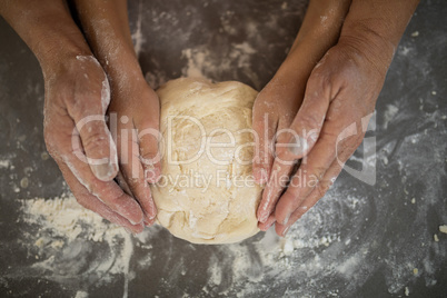 Grandmother and granddaughter holding dough in their hand