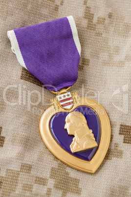 Purple Heart Medal Laying on Military Fatigues