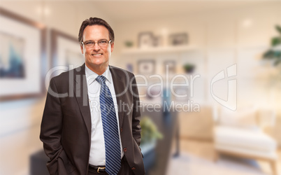 Handsome Businessman In Suit and Tie Standing in His Office