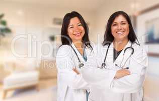 Female Hispanic Doctors or Nurses Standing in an Office