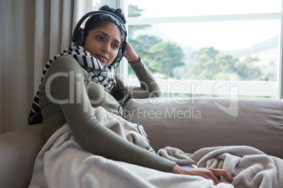Relaxed woman listening to music at home