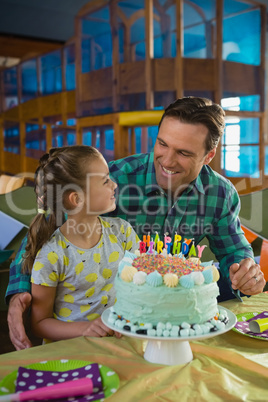 Father and daughter with birthday cake