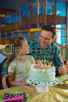 Father and daughter with birthday cake