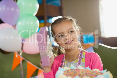 Birthday girl holding a gift box