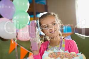 Birthday girl holding a gift box