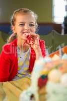 Cute girl blowing party horn during birthday party