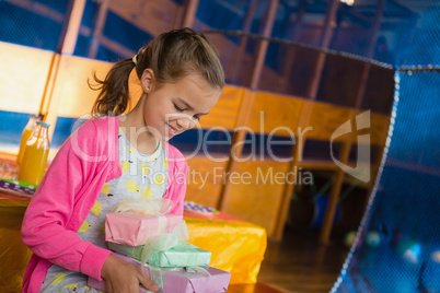 Birthday girl holding various gift boxes