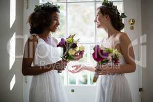 Bride and bridesmaids standing with bouquet