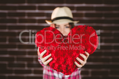 Smiling woman showing heart shape