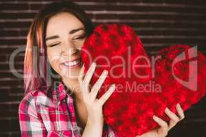 Smiling woman holding heart shape