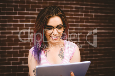 Smiling woman using digital tablet