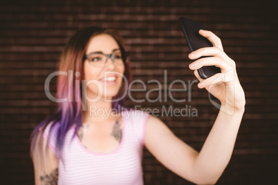 Smiling woman taking selfie from mobile phone