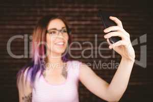 Smiling woman taking selfie from mobile phone