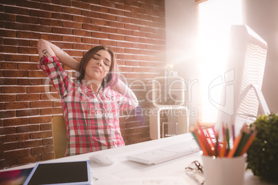 Female executive relaxing at her desk
