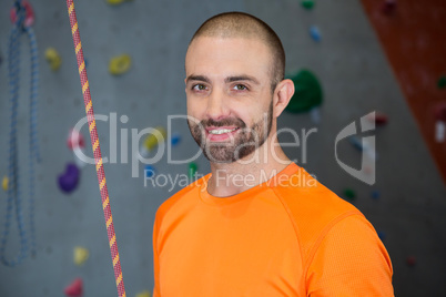 Trainer standing with rope in fitness studio