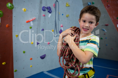 Boy standing with rope in fitness studio