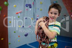 Boy standing with rope in fitness studio