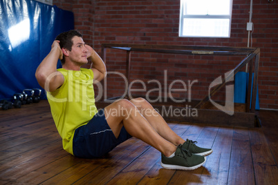 Determined man performing crunches