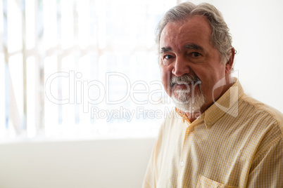 Portrait of senior man relaxing at retirement home