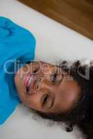 Portrait of girl lying on bed in clinic