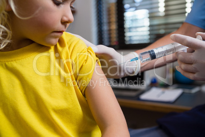 Physiotherapist injecting girl patient