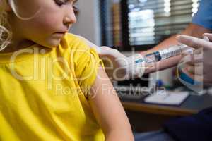 Physiotherapist injecting girl patient